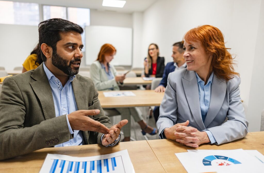 Business owner offering services to another company in a B2B meeting